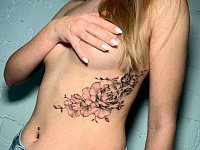 Татуировка цветы под грудью
