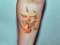 тату знак Ом с лицом