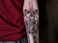 Татуировка в стиле биомеханика на предплечье