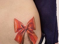 женская тату бант