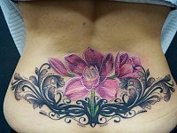 Тату орхидея на пояснице